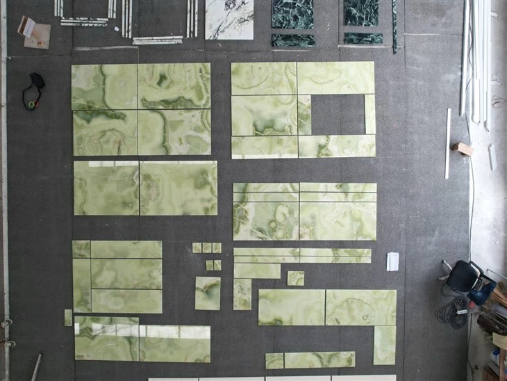 Full factory dry layout of polished Green Onyx tiles arranged after cutting to inspect piece relationships, vein alignment, color coordination and finished quality.